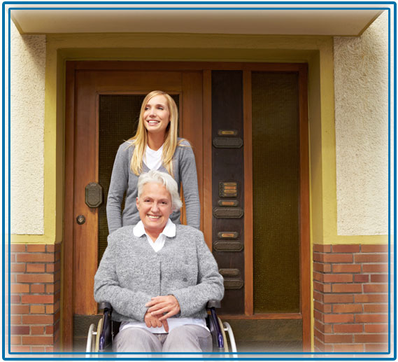 Lady in wheelchair in front of building